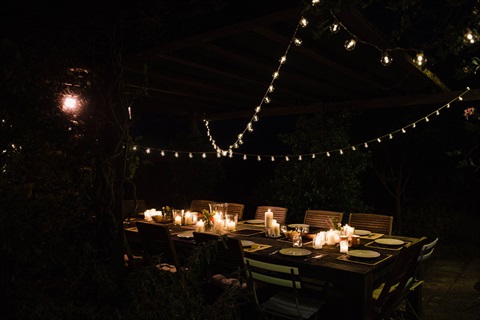 Outdoor table with fairy lights at night