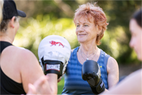 Older women wearing active wear with boxing gloves