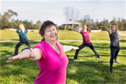 Group of women doing yoga in a park