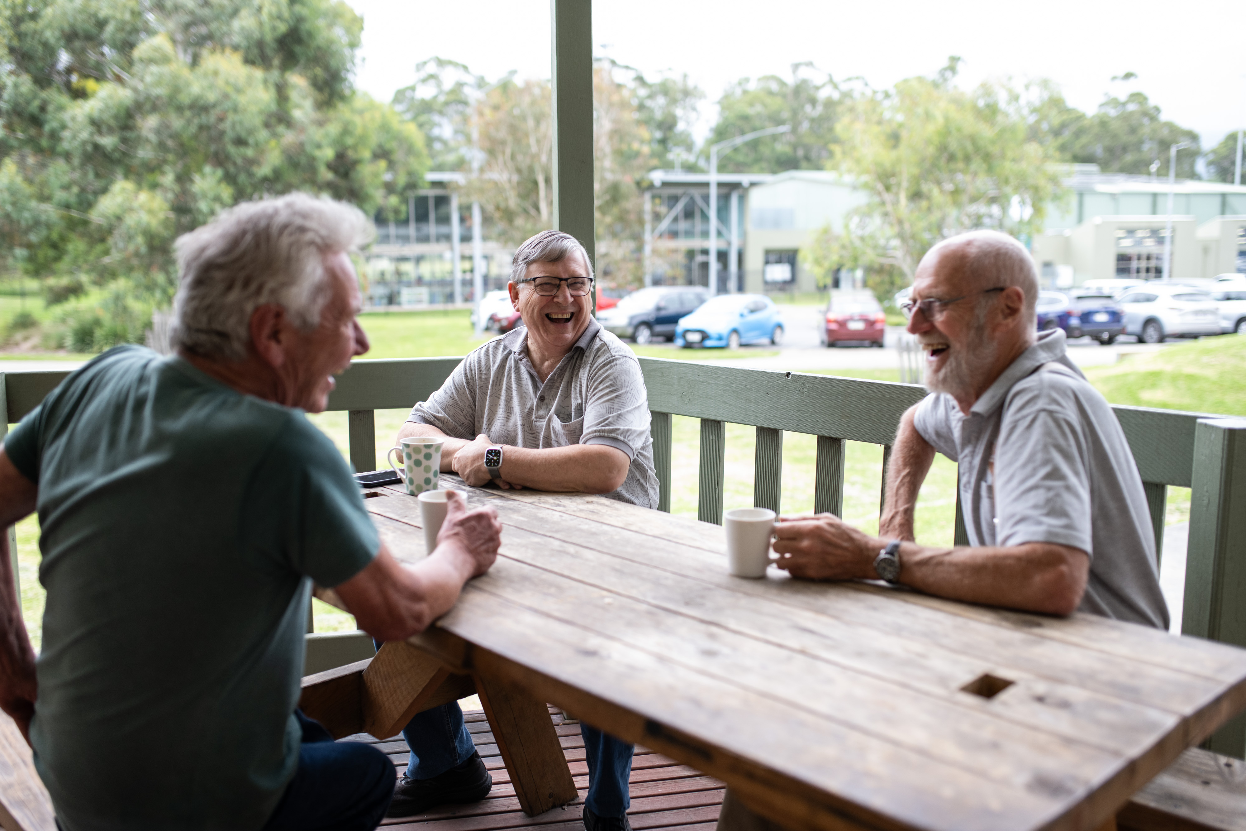 Men sitting around a table having a cuppa together