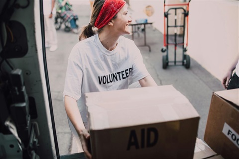 Volunteer unloading box from a truck