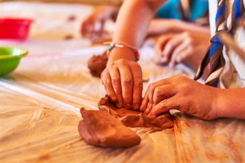 person creating with clay