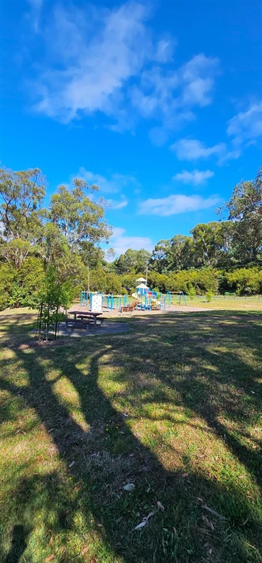 Picnic table with view of play equipment