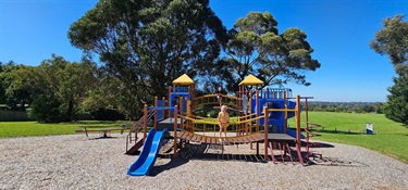 Play equipment featuring towers, slides, climbing elements and tunnels