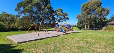 Play equipment featuring swing and tower