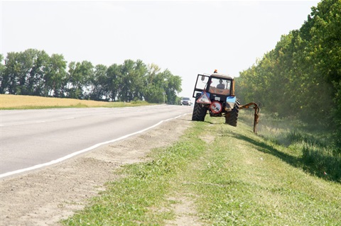 Tractor mowing roadside