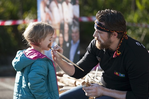 A person painting a childs face at the Wurun Chidl and Family Place opening