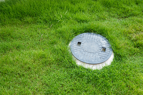 Septic tank pit in the lawn